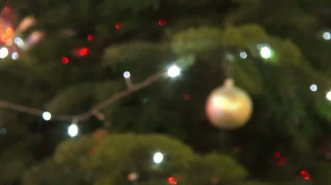Out of focus Christmas tree, blurred lights, Christmas ball, holiday, presents Stock Footage 33073423