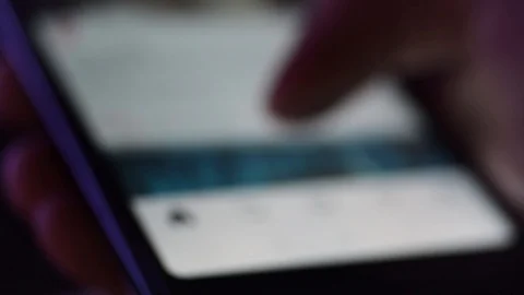Out of focus, closeup macro, hand using smartphone on social media screen Stock Footage 95157295