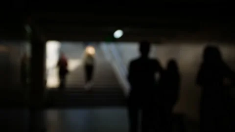 Out of focus of the crowd of people walking through the underpass Stock Footage 154159357