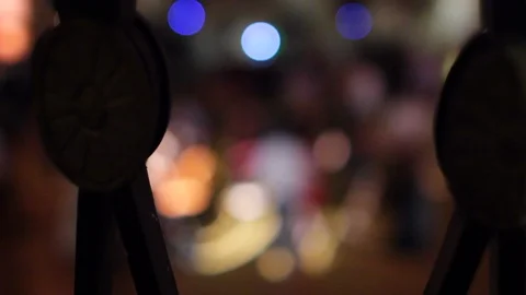 Out of focus dancing between foreground railing Stock Footage 92203137