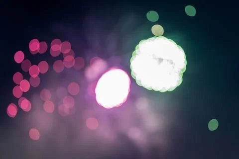 Out of focus exploding fireworks in the night sky Foto stock