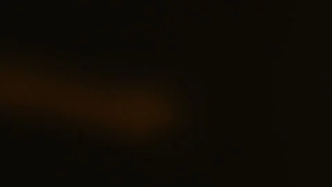 Out of focus extreme macro close-up of a small light bulb filament flashing on Video stock 327905711