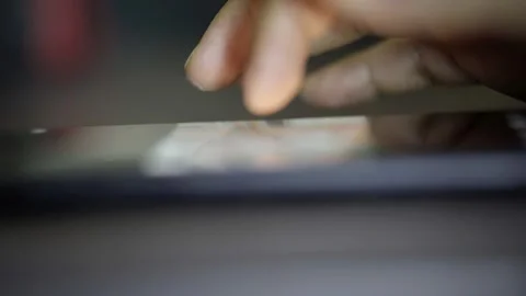 Out-of-focus hand of a man using social networks through his cell phone Stock Footage 272254587