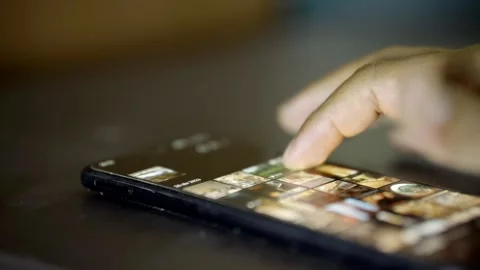 Out-of-focus hand of a man using his cell phone, content not visible Stock Footage 272254671