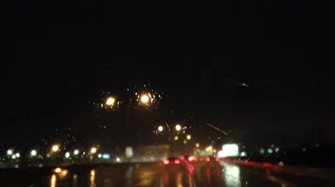 Out of focus on heavy raining night of car driving on highway. Stock Footage 48378339