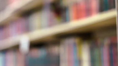 Out of focus horizontal view of blue and white book spines on a library shelf Stock Photos