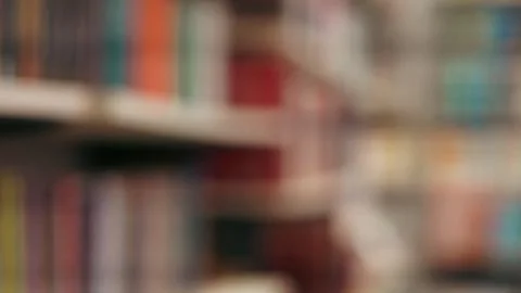 Out of focus horizontal view of blue and white book spines on a library shelf Stock Photos