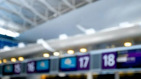 Out of focus image of display on top of flight check-in zone in airport terminal Stock Photos