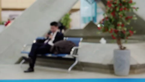 Out of focus man with phone sitting on bench Stock Footage 150270645