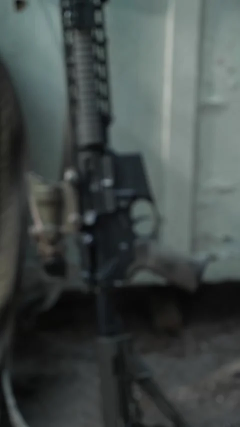 Out of focus modernized assault rifle with blurred background Stock Footage 333612759