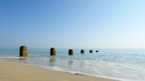 Out of focus of a peaceful scene of calm waves lapping up against beach Stock Footage 72579554