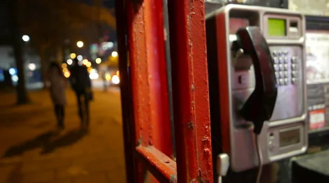 Out of focus people walking by broken telephone booth Stock Footage 45210092