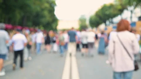 Out-of-focus people walking down the street during a busy public event with a Video stock 345882794