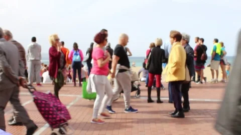 Out of focus of people walking on the seafront promenade Stock Footage 72130675