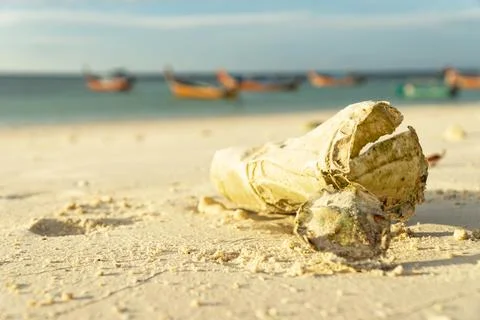 Out of focus plastic on the sand That take many years to decompose Show the p Stock Photos