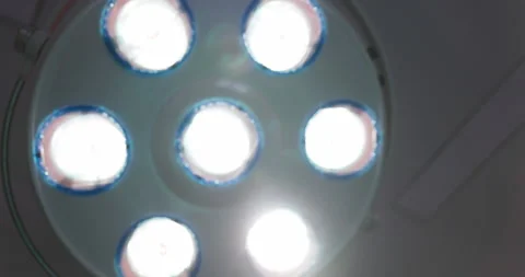 Out of focus pull on surgeon lights at hospital or dentist. Surgical light in op Stock Footage 163262909