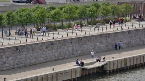 Out of focus scene of people walking on the sidewalk.  Stock-Footage 77169062