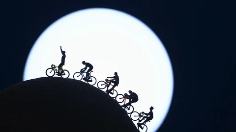 Out of focus to sharp focus miniature toys - mountain climbers reaching the top. Stock Footage 128093549