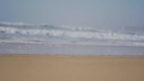 Out of focus shot of sea waves on beach with cloudy sky, Portugal Stock Footage 129065843