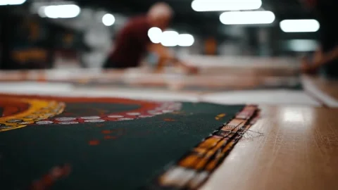 Out of focus shot of workers cutting fabric Stock Footage 135160637