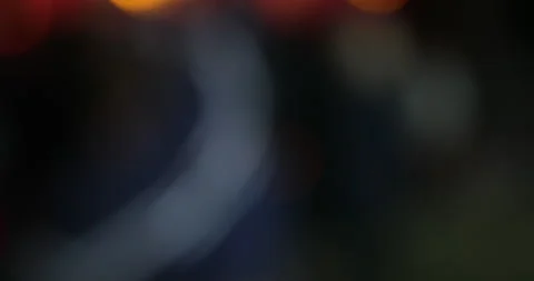 Out of focus silhouette of a juggler with multi-colored balls slow motion Stock Footage 130476211