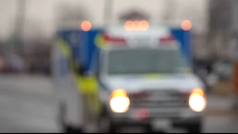Out-of-focus slow moving ambulance vehicle  Stock Footage 1073015