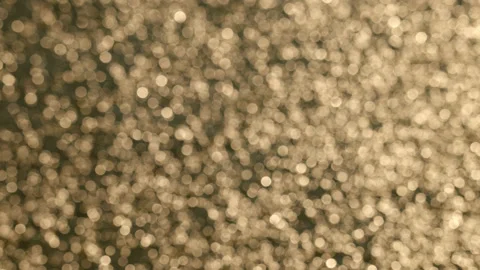 Out of focus sparkling water creates bokeh ball patterns - close up. 4K Stock Footage 234725144