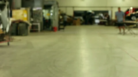 Out of focus, techs working in auto body shop Stock Footage 25879007