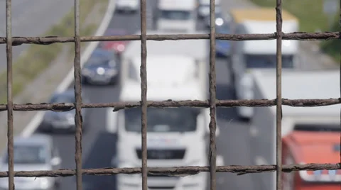 Out of focus traffic through wire fence Stock Footage 39457453
