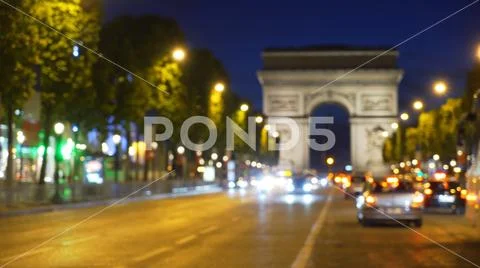 Out of focus view of Champs-Elysees in Paris with Arc de Triomphe in view Stock Photos