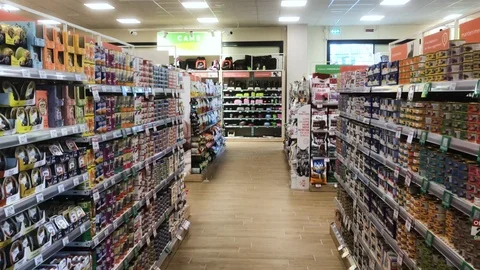 Out of focus: walking between the shelves of a store to make purchases Stock Footage 96079712