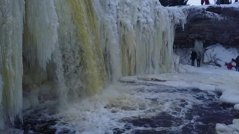 Out of iced cave to waterfall Stockbeeldmateriaal 72634093