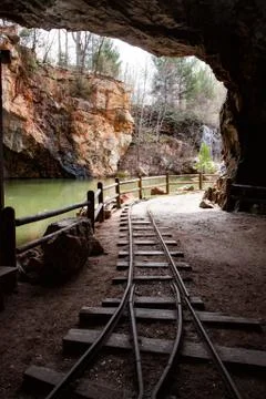 Out from the mining cave, with train tracks Stock Photos