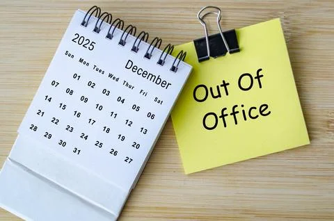 Out of office text on notepad with December calendar. Christmas Celebration.. Stock Photos