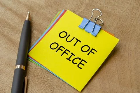 Out of office text on yellow notepad. Away from work or getaway concept. Stock Photos