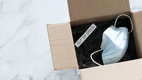 Out of stock text inside of empty delivery parcel with surgical mask, supply  動画素材 205801554