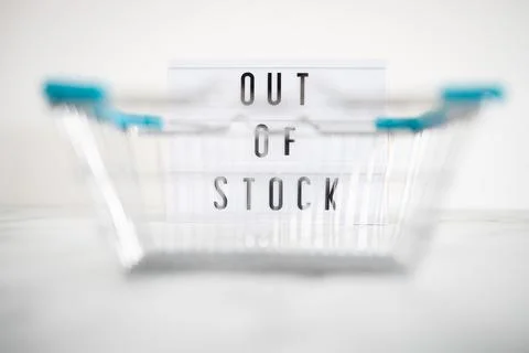 Out of stock text on lightbox with empty shopping basket bokeh on white backg Stock Photos