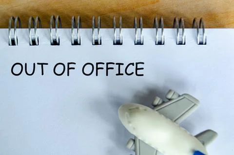 Out Of Off text on white notepad with small airplane. Out of office concept.. Stock Photos