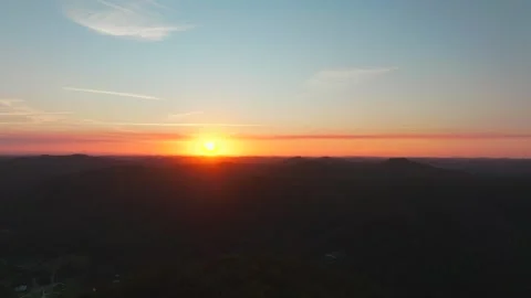 Outback orange yellow vibrant sunset sunrise on mountain layers horizon Stock Footage 287587812