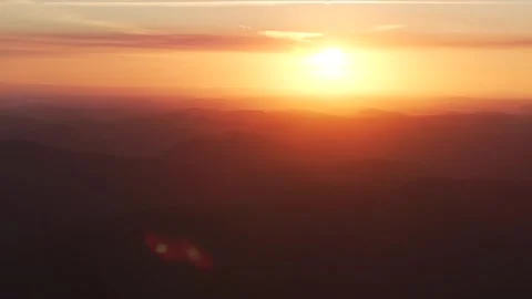 Outback orange yellow vibrant sunset sunrise on mountain layers horizon Stock Footage 287588602