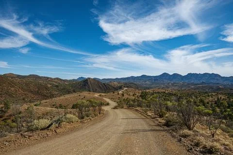 Outback Road with Mountainous Backdrop Stock Photos