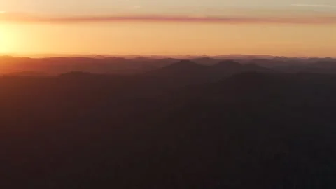 Outback vibrant orange mountain layers sunset sunrise aerial drone horizon Stock Footage 287587704