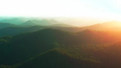Outback vibrant orange sun flare mountain layers sunset sunrise aerial Stock Footage 287588116