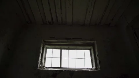 Outdated building window with wooden boards and metal grid Stockbeeldmateriaal 135516520