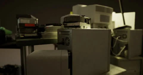 Outdated computer equipment in a dimly lit workspace environment Stock Footage 305440134