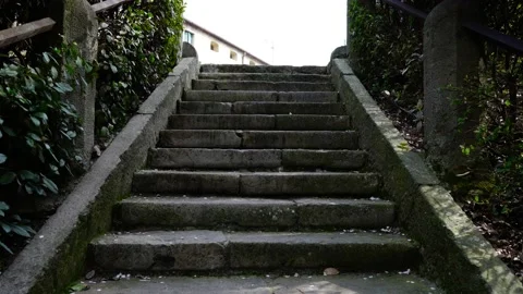 Outdated grey stairs with brown metal rusty handrails 库存影片 150495352