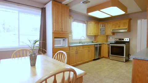 A outdated kitchen and living room space inside a residential family home 스톡 동영상 161497175