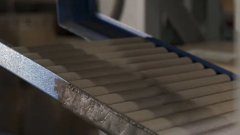 Outdated machine in production, cardboard tubes, person puts new tubes in queue Stock Footage 119195425