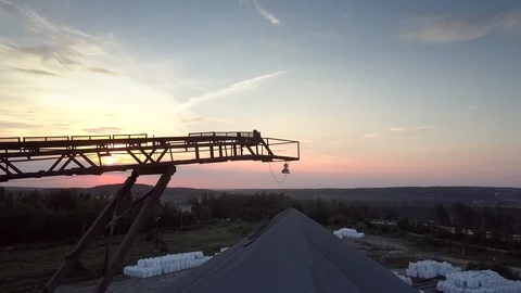 Outdated mining sector elements against orange sky Stock Footage 114426133