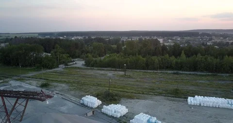 Outdated mining sector elements under orange morning sky Stock Footage 115673847